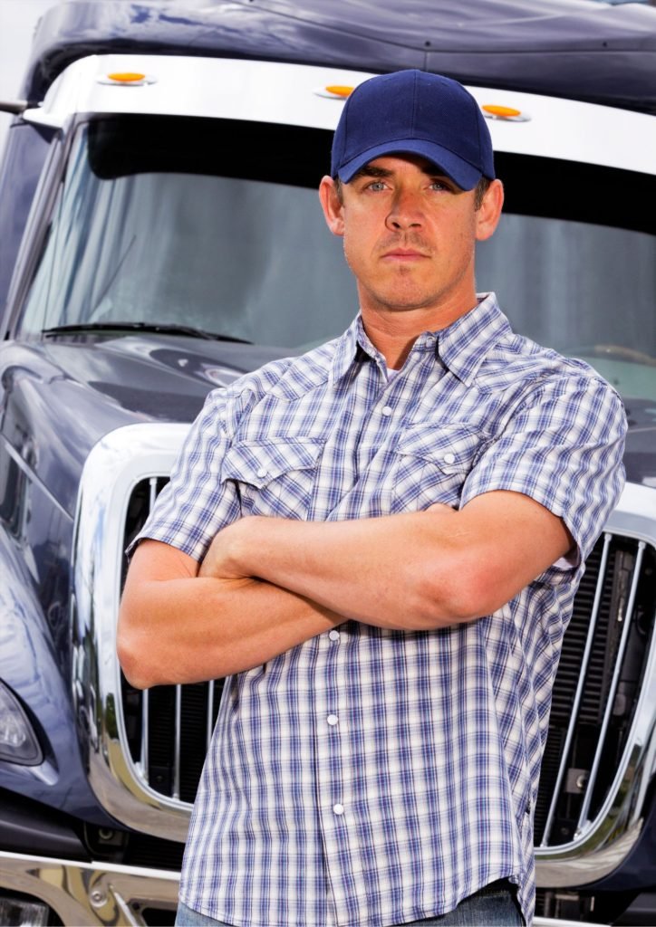 Man in front of big truck